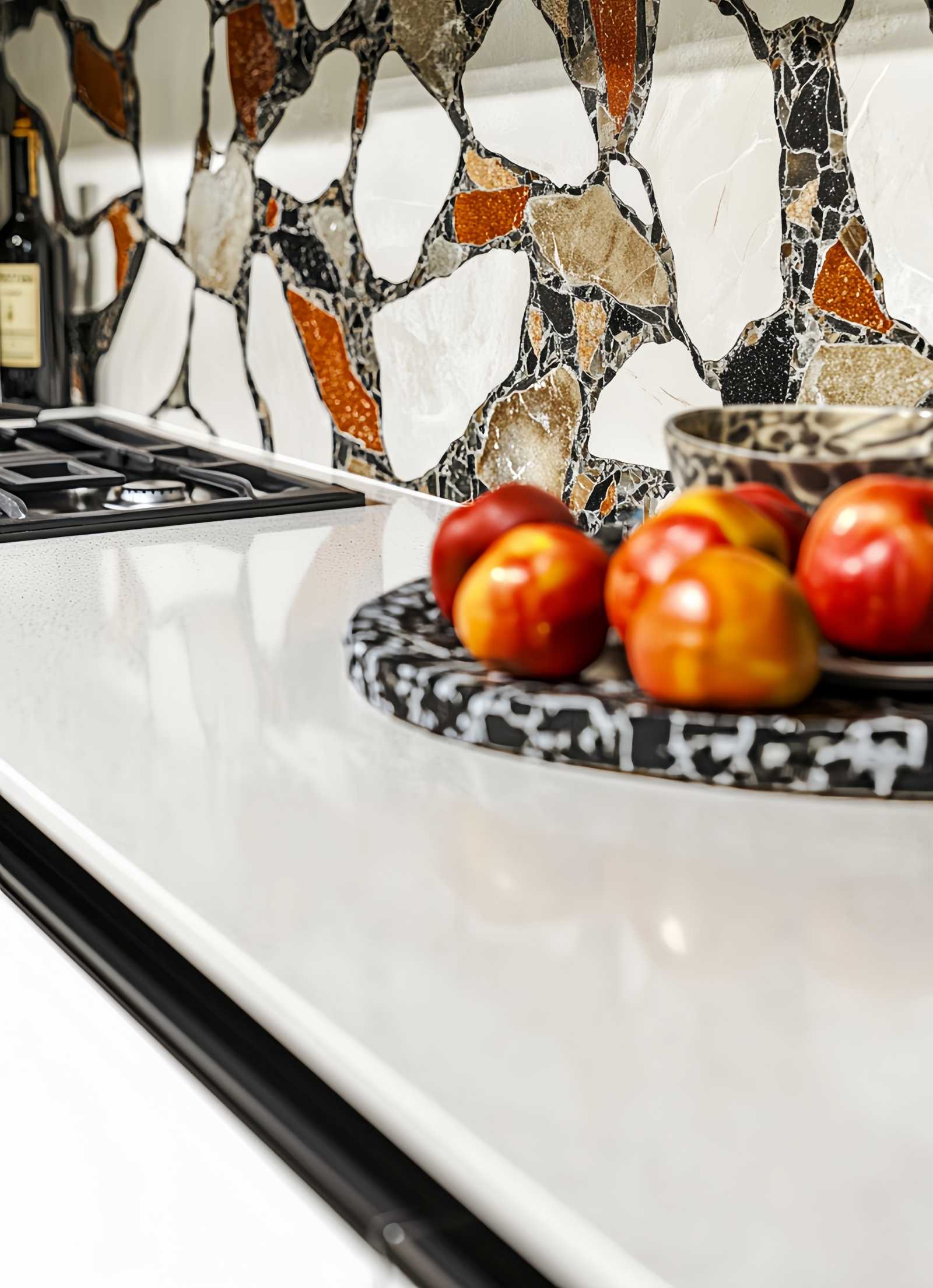 a kitchen, highlighting intricate patterns with quartz and recycled glass