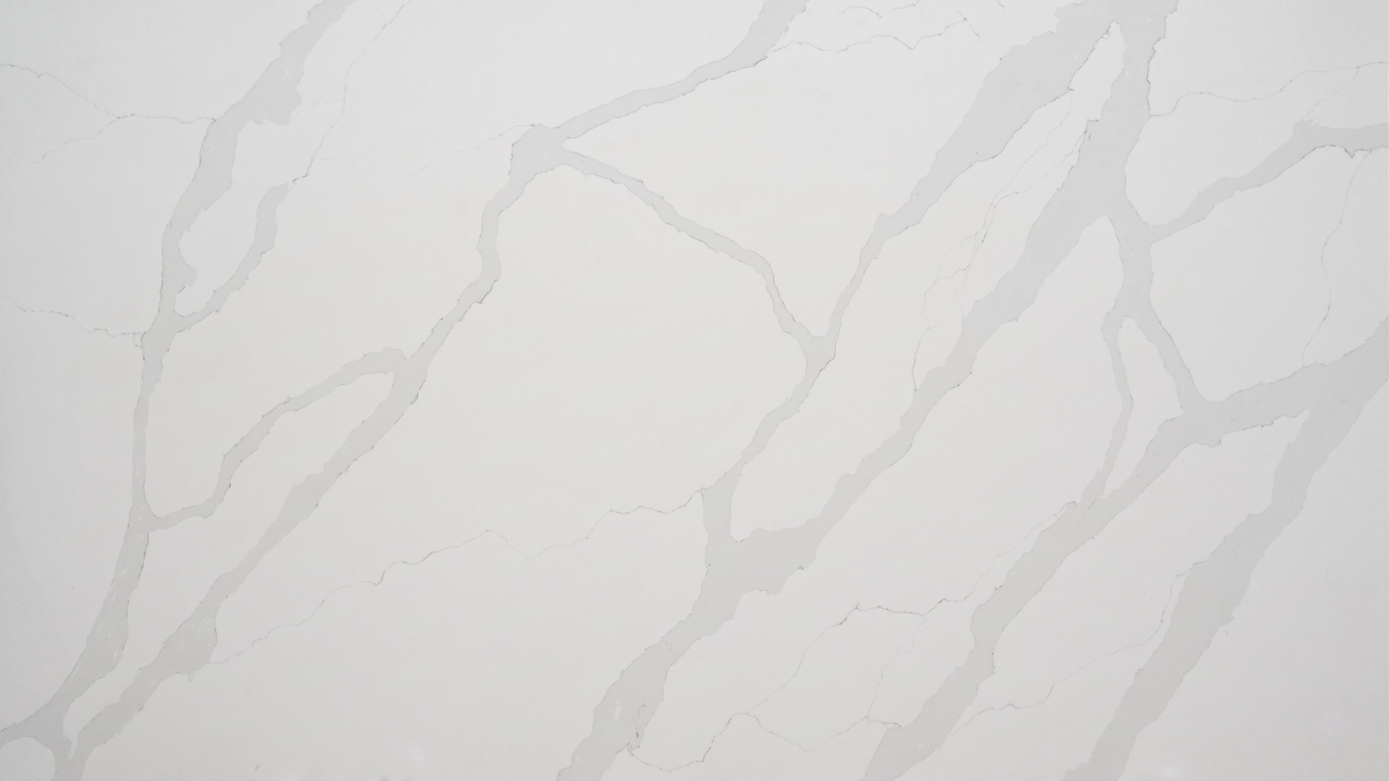 Soft Calacatta Quartz slab with white base and broad soft grey veining