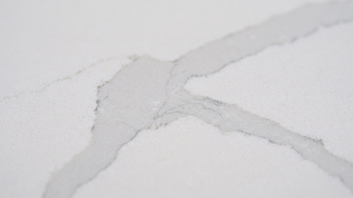 Close-up of soft grey ribbon veining in white quartz stone