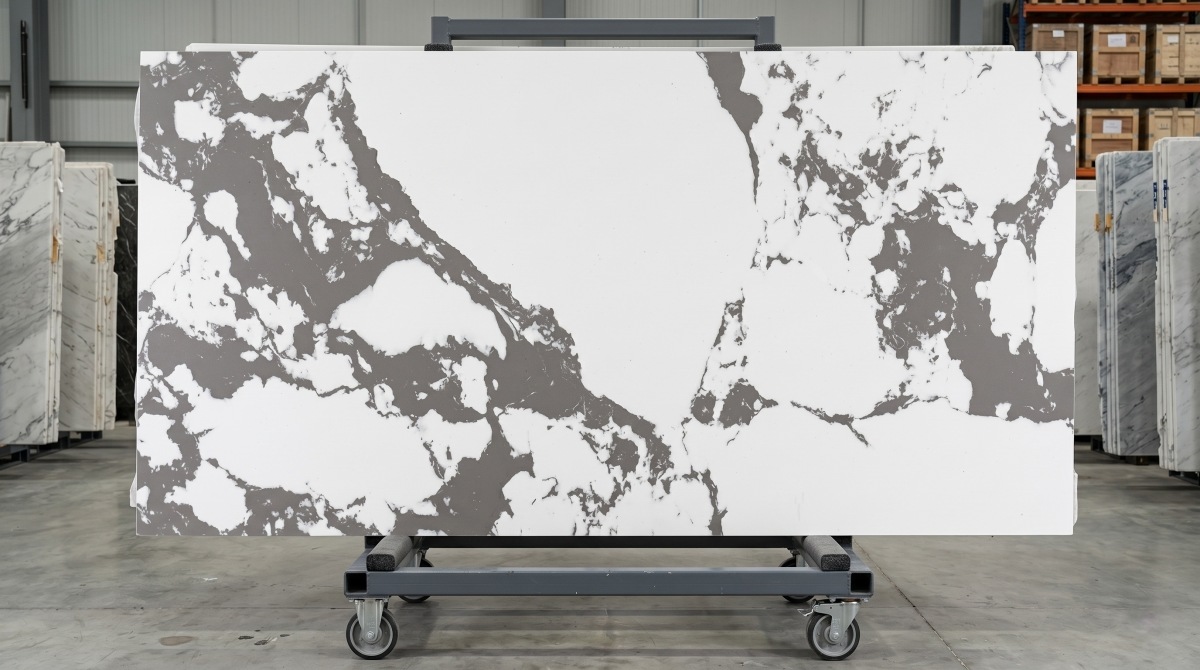 Full slab display of Bulgary Vein White Artificial Marble on a showroom rack