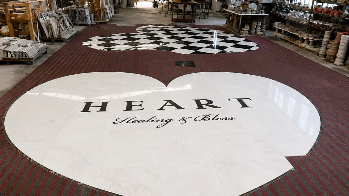 White marble heart-shaped floor medallion with HEART lettering in factory pre-layout stage