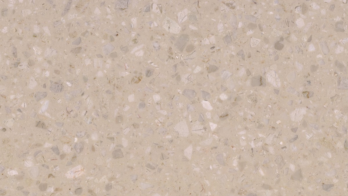 Beige artificial marble tile close-up showing fine mineral particles and light chips