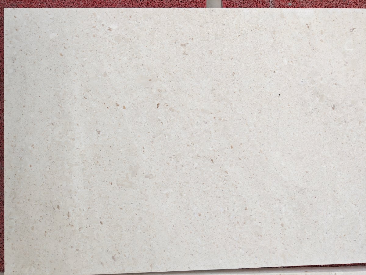 cotswold-cream-limestone-honed-surface-close-up Close-up view of Cotswold Cream Limestone honed surface with fossil texture and soft beige tone