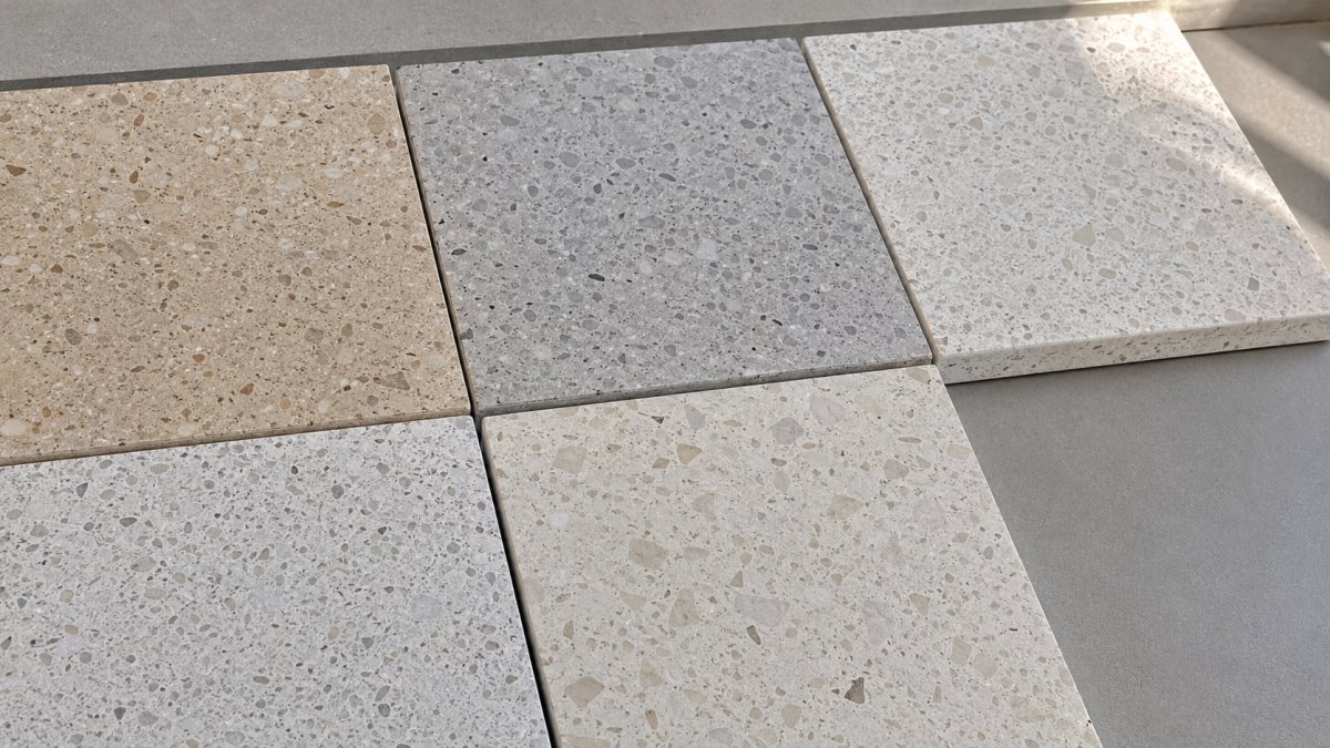 Close-up comparison of terrazzo samples with different matrix color tones