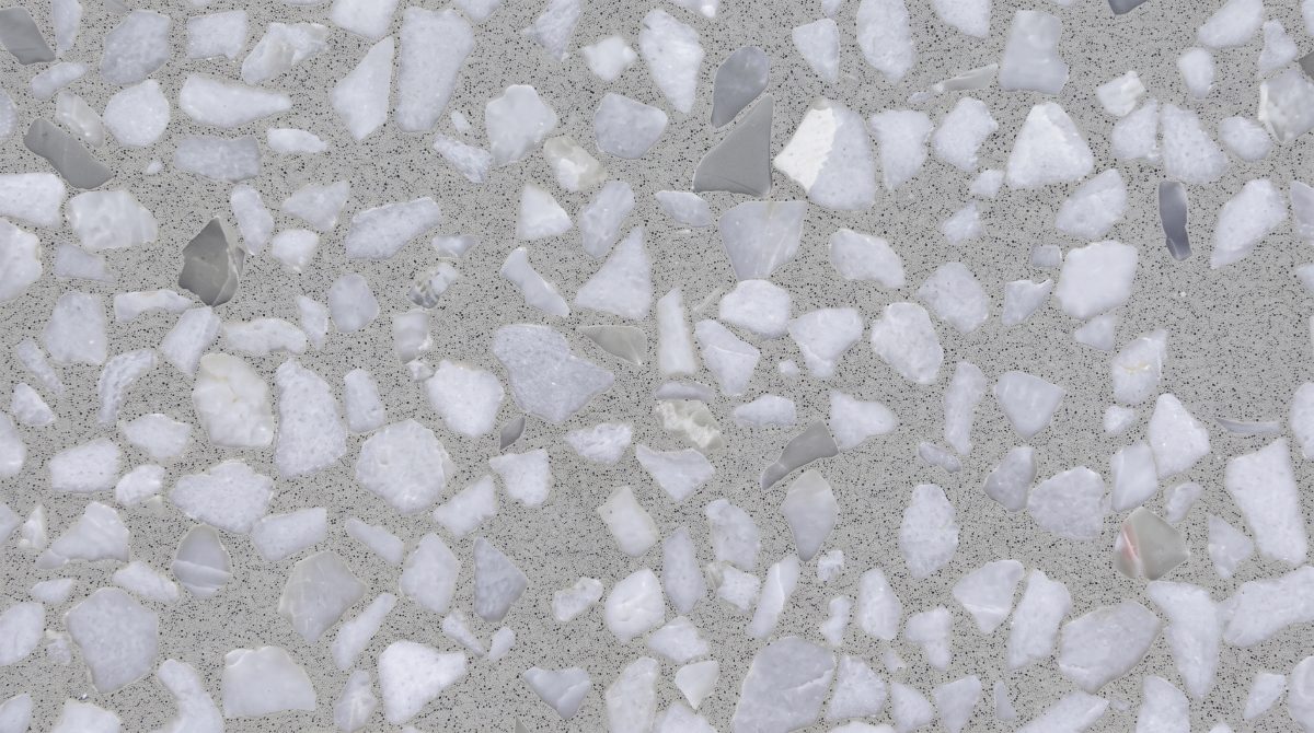 grey-terrazzo-white-marble-chip-close-up-texture Close-up of grey terrazzo surface with white marble chips, light grey aggregates and fine dark speckles.