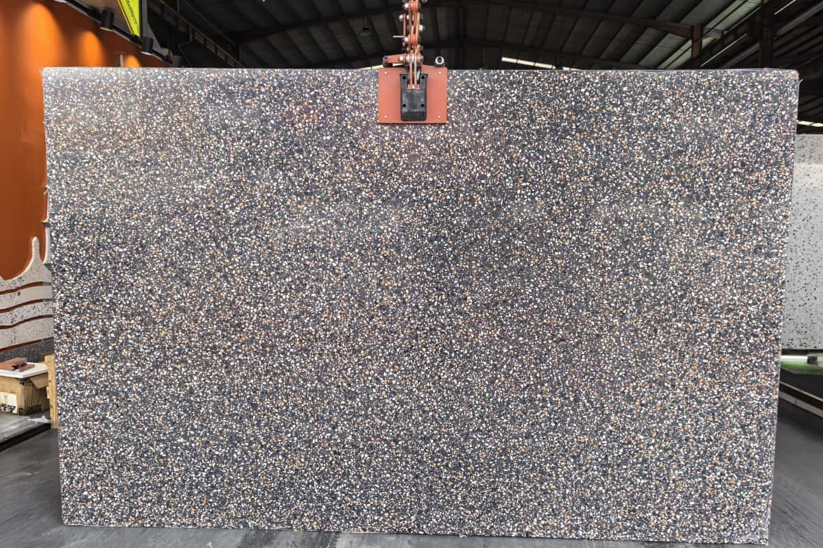 amber-night-black-terrazzo-full-slab •Full Amber Night black terrazzo slab showing dense white and amber chip distribution •Status: Real evidence; reshoot recommended