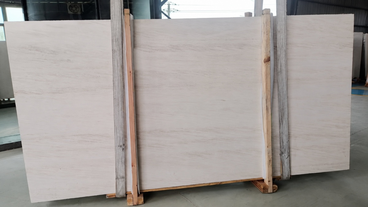 french-wood-grain-limestone-full-slabs Full slabs of pale French Wood Grain Limestone on a timber-supported storage rack