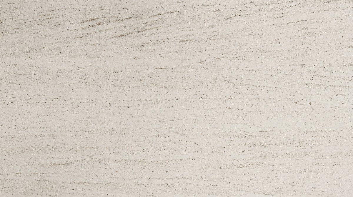 french-wood-grain-limestone-edge-thickness-detail Close-up of pale ivory limestone with fine linear grain, small pores and natural speckles